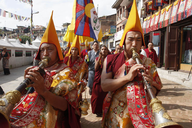 Tibetan exile monks play traditional music instruments as they take out a procession on the 48th Tibetan democracy day in Baudhanath Stupa, unseen, one of the holy Buddhist monuments in the outskirts of Katmandu, Nepal, Tuesday, Sept. 2, 2008. (AP Photo/Binod Joshi)